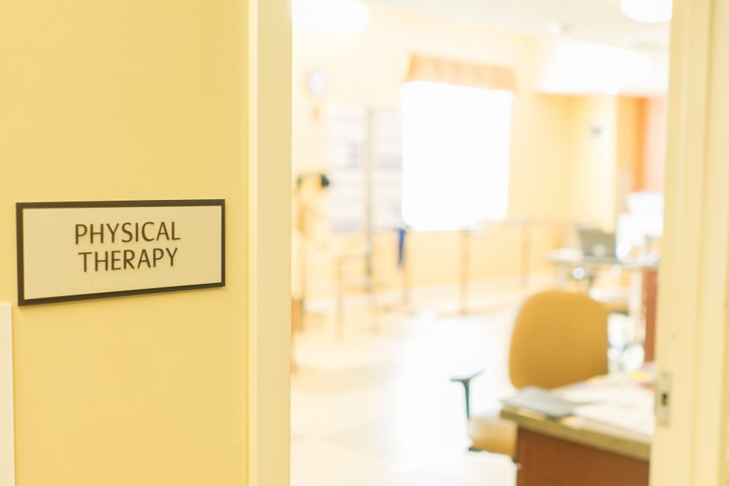 Interior view of a physical therapy room with signage