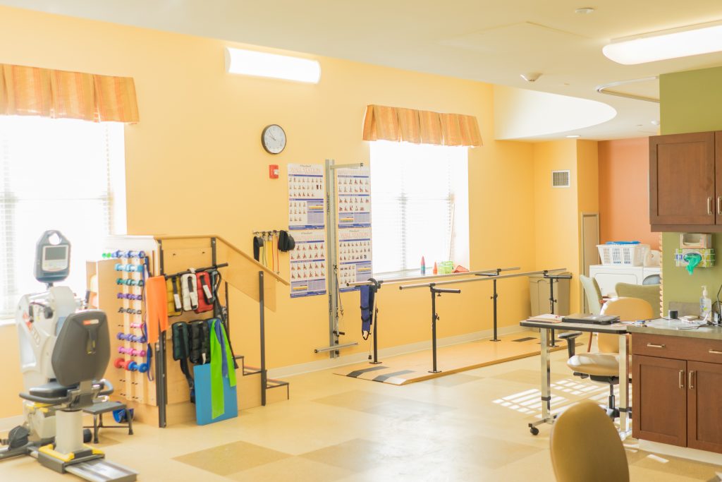 Rehabilitation room with exercise equipment and therapy bars
