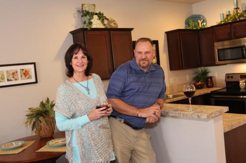 Residents enjoying a drink in a modern kitchen.