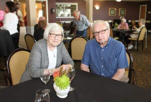 Two residents enjoying a meal in the dining room