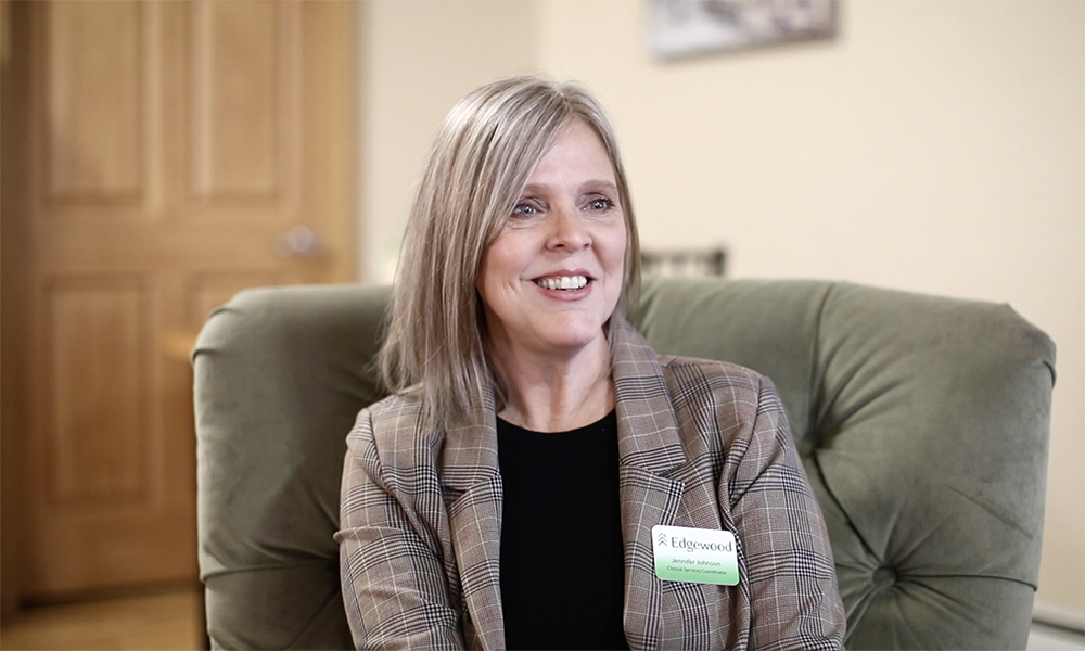 Smiling staff member in a cozy interior setting