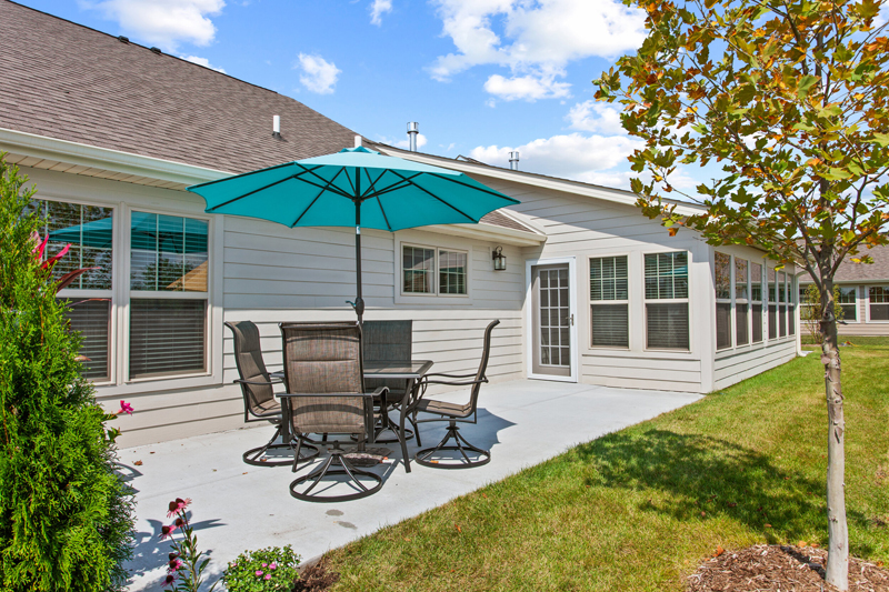 Outdoor patio area with seating and an umbrella