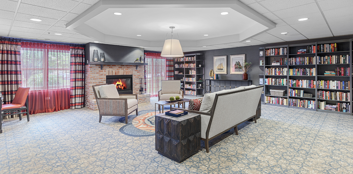 Cozy common area with bookshelves and a fireplace