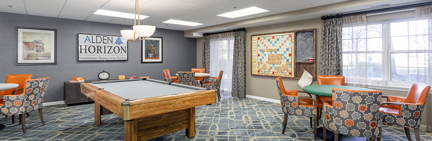 Bright common area with seating and a pool table