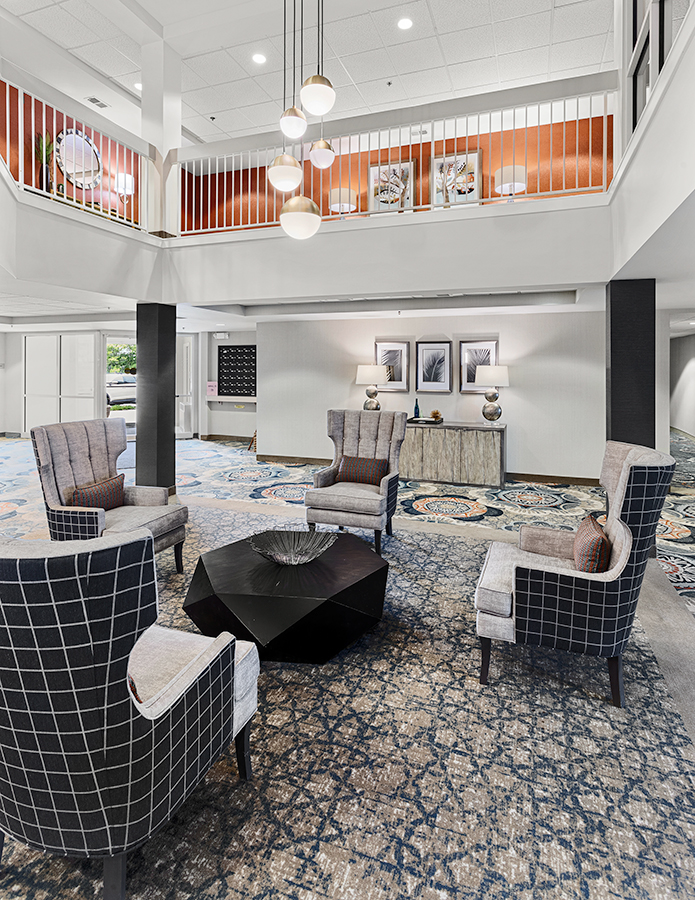 Interior common area with upholstered chairs and a decorative table