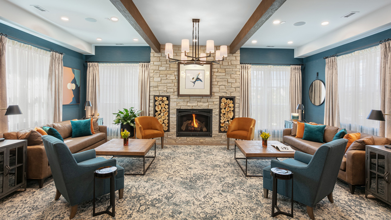 Warm and inviting common area with seating and fireplace