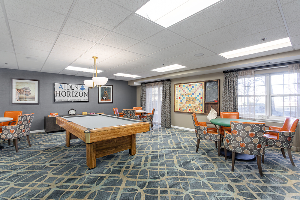 Interior activity room with pool table and seating