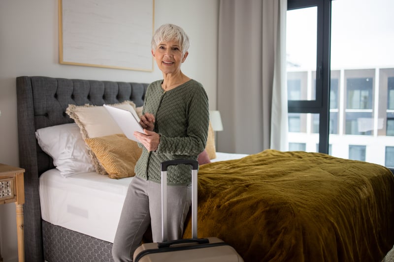 A resident preparing for a move with luggage in a comfortable room