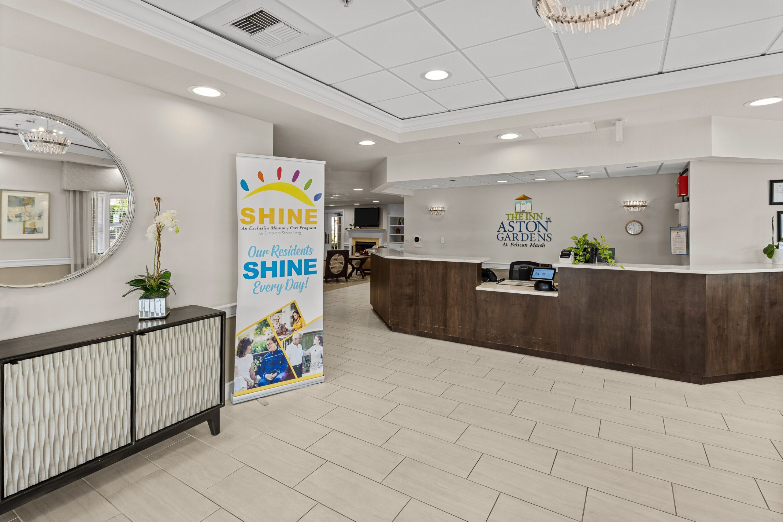 Bright lobby area with a reception desk and banner