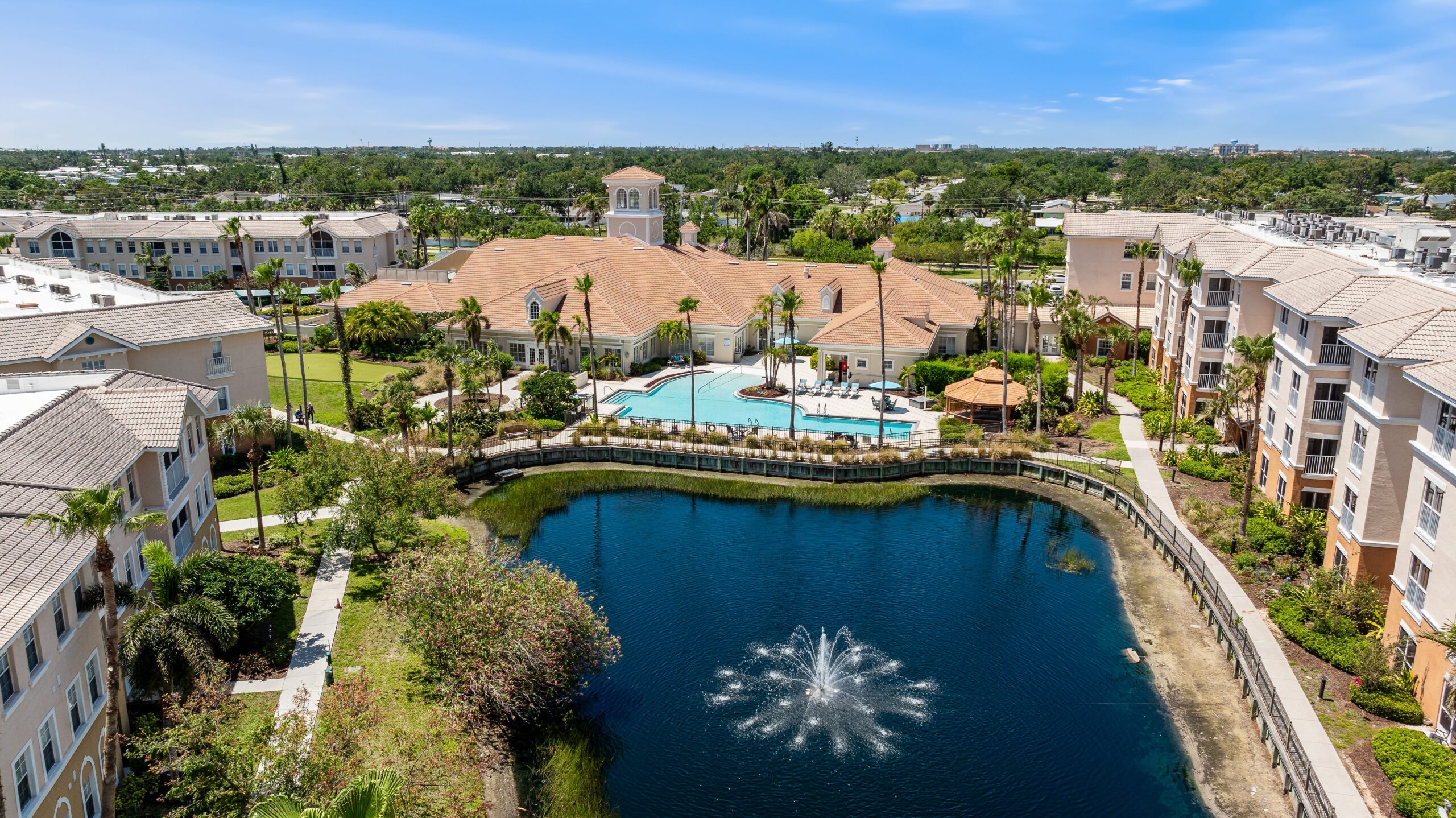 Aerial view of Aston Gardens with pool and lake
