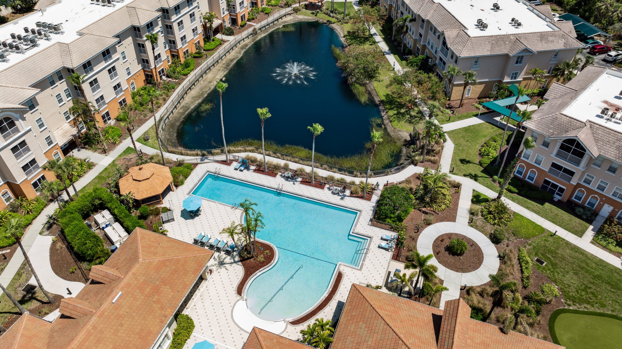 Aerial view of the pool and landscaping at Aston Gardens