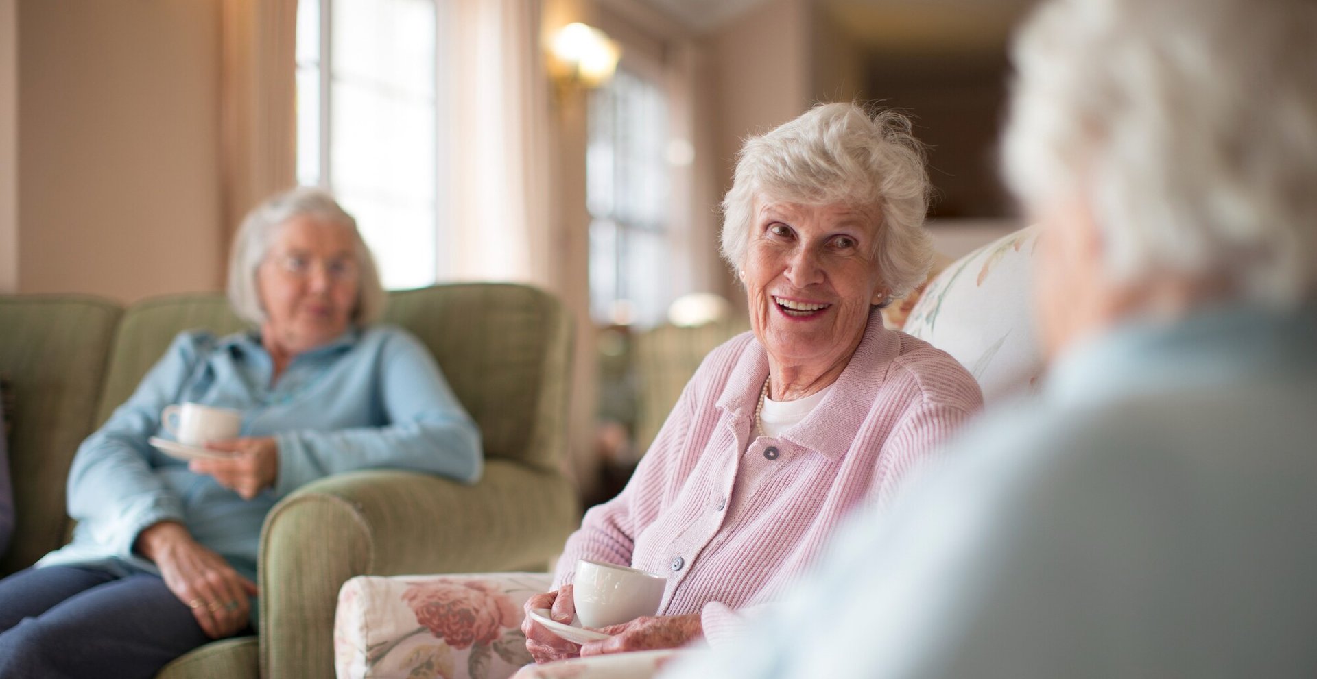 Residents enjoying conversation in a cozy lounge area