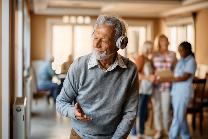 Resident enjoying music in a lively common area