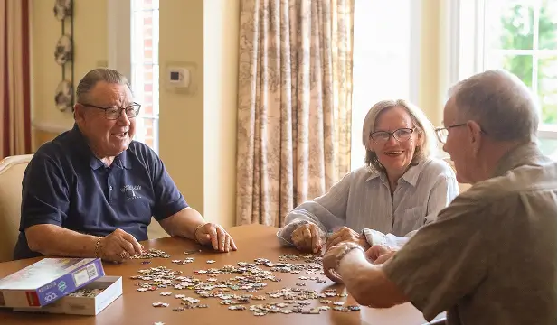 Residents enjoying a puzzle activity at a table