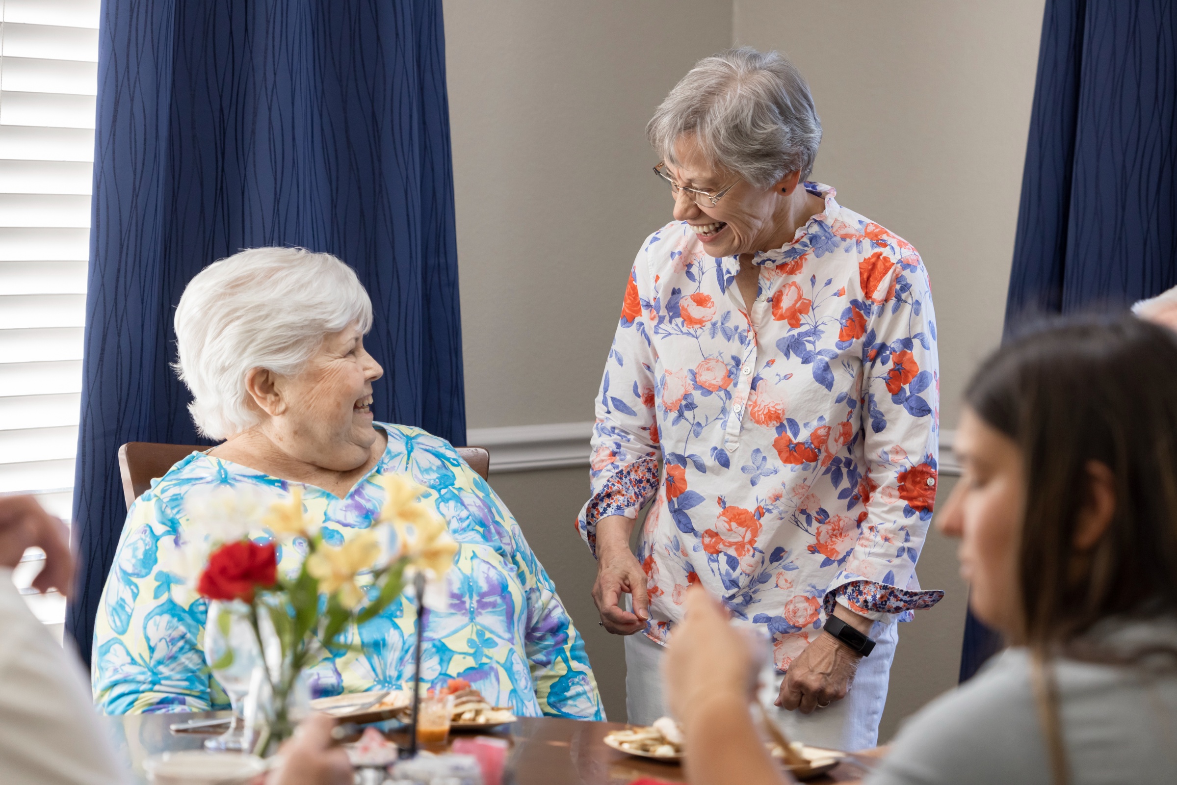 Two residents enjoying a meal and conversation