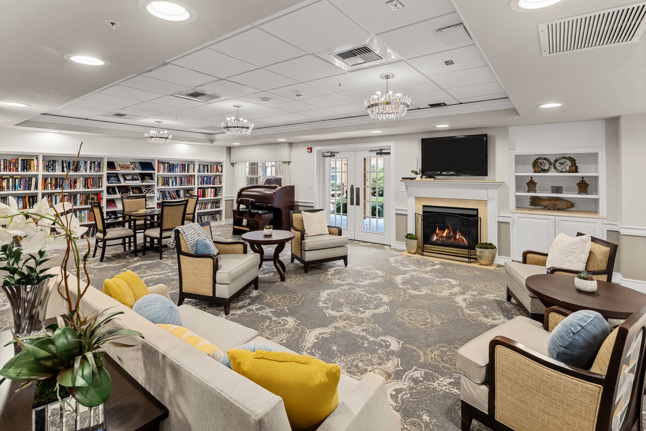 Bright and airy common area with bookshelves and seating