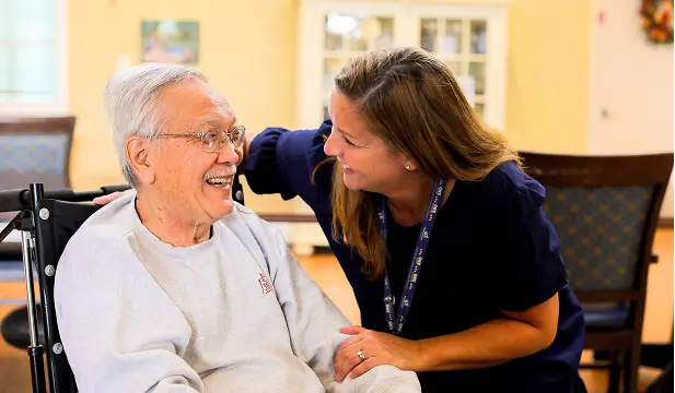 Staff member interacting warmly with a resident