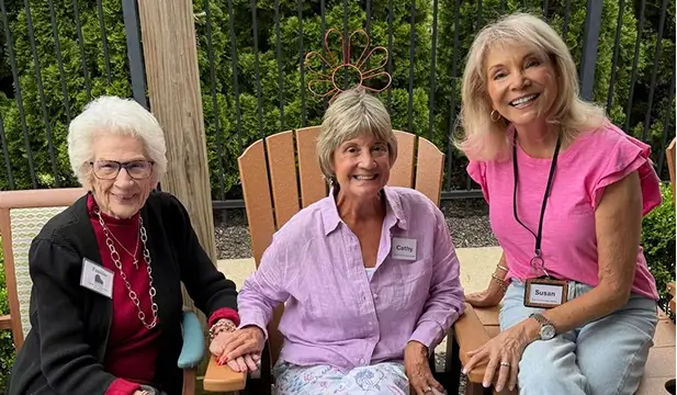 Three residents enjoying time together outdoors