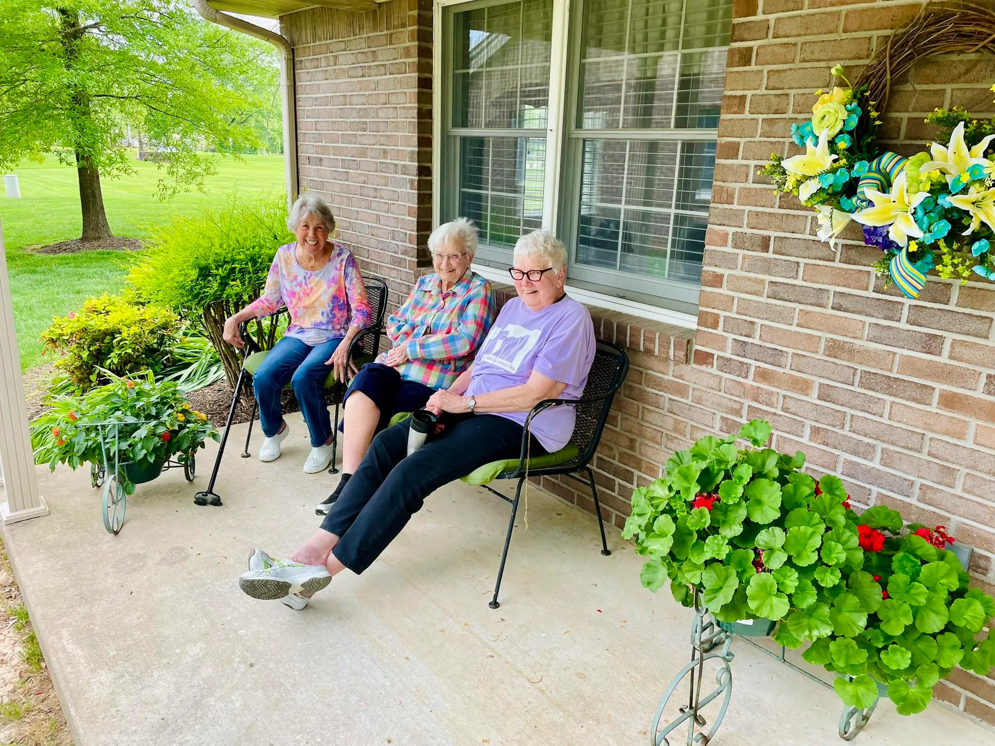 Three residents enjoying the outdoors on a patio