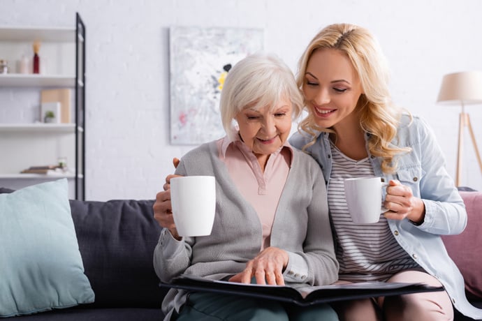 A caregiver and resident enjoying a photo album together