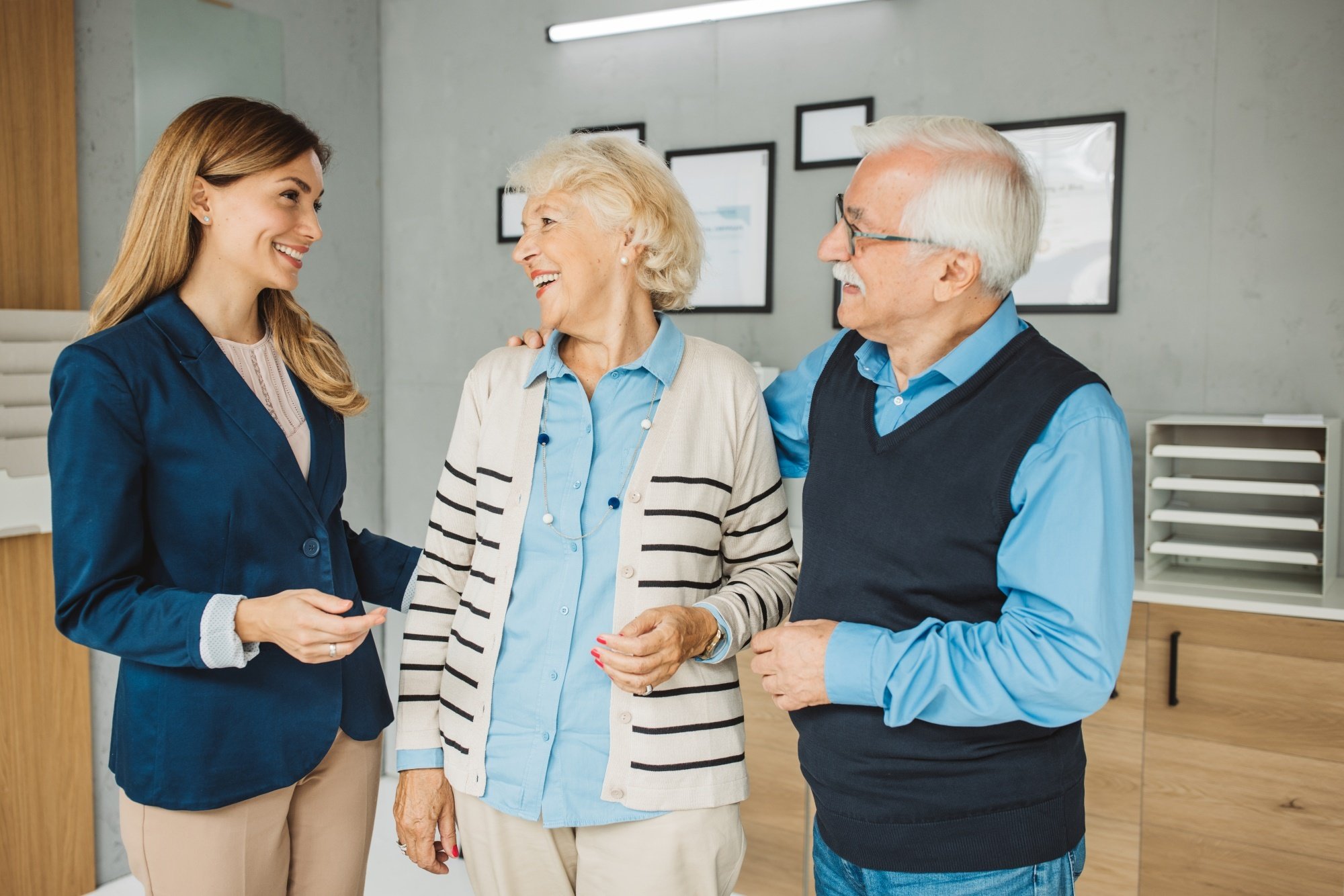 Staff interacting with cheerful residents in a lobby setting
