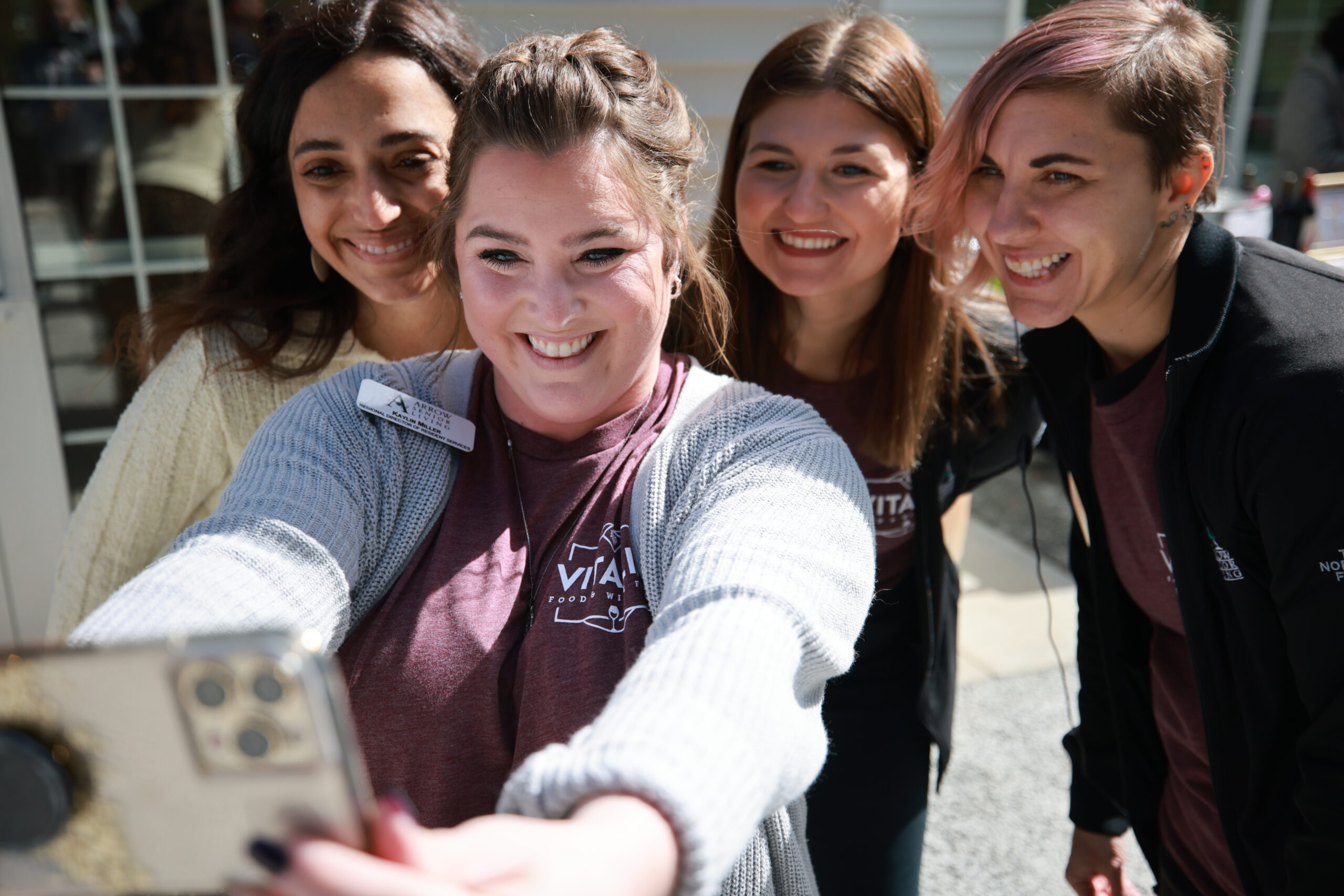 Residents and staff posing for a selfie at an outdoor event