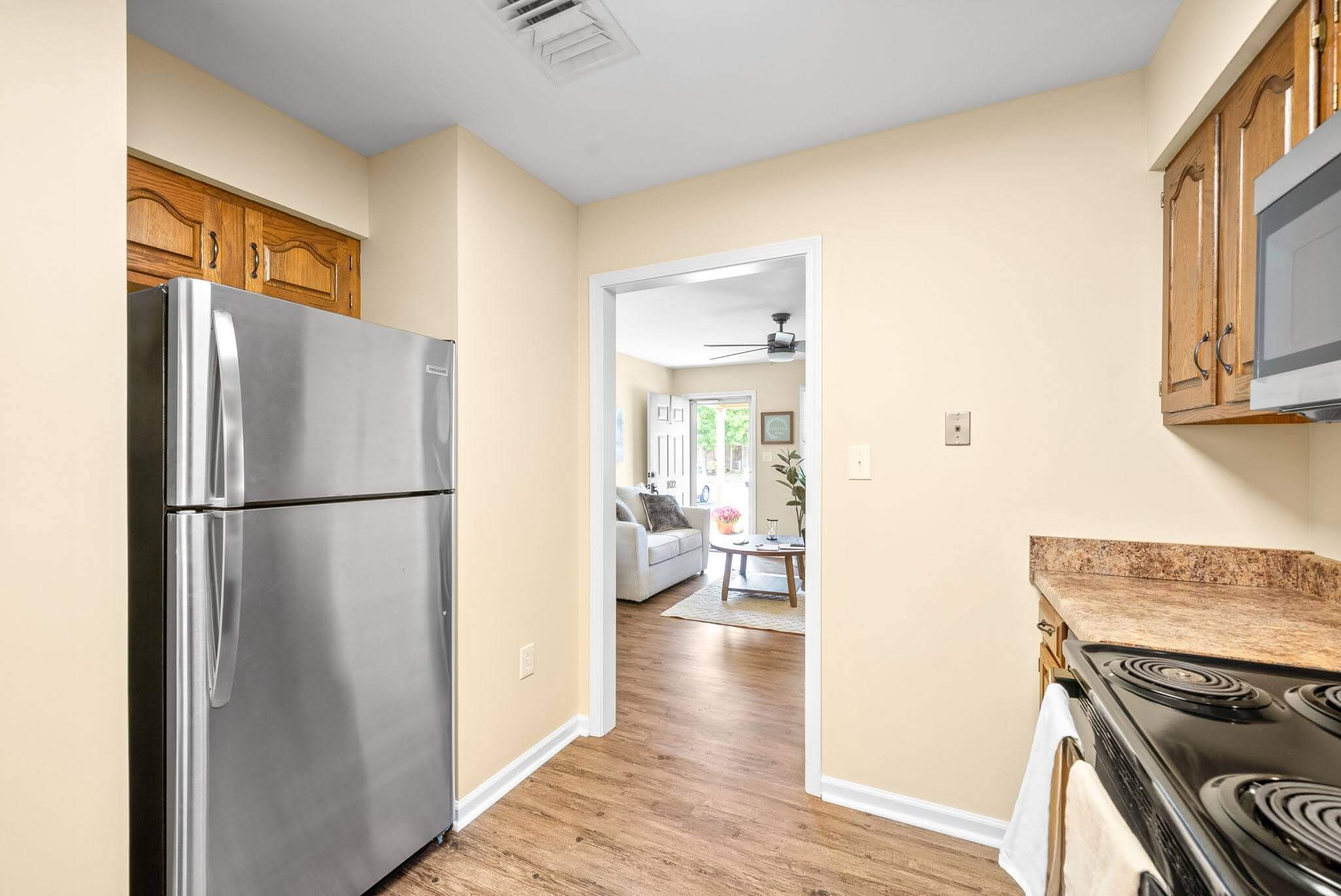 View of a kitchen leading to a living area