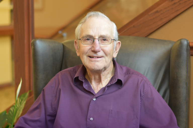 Resident smiling in an indoor setting
