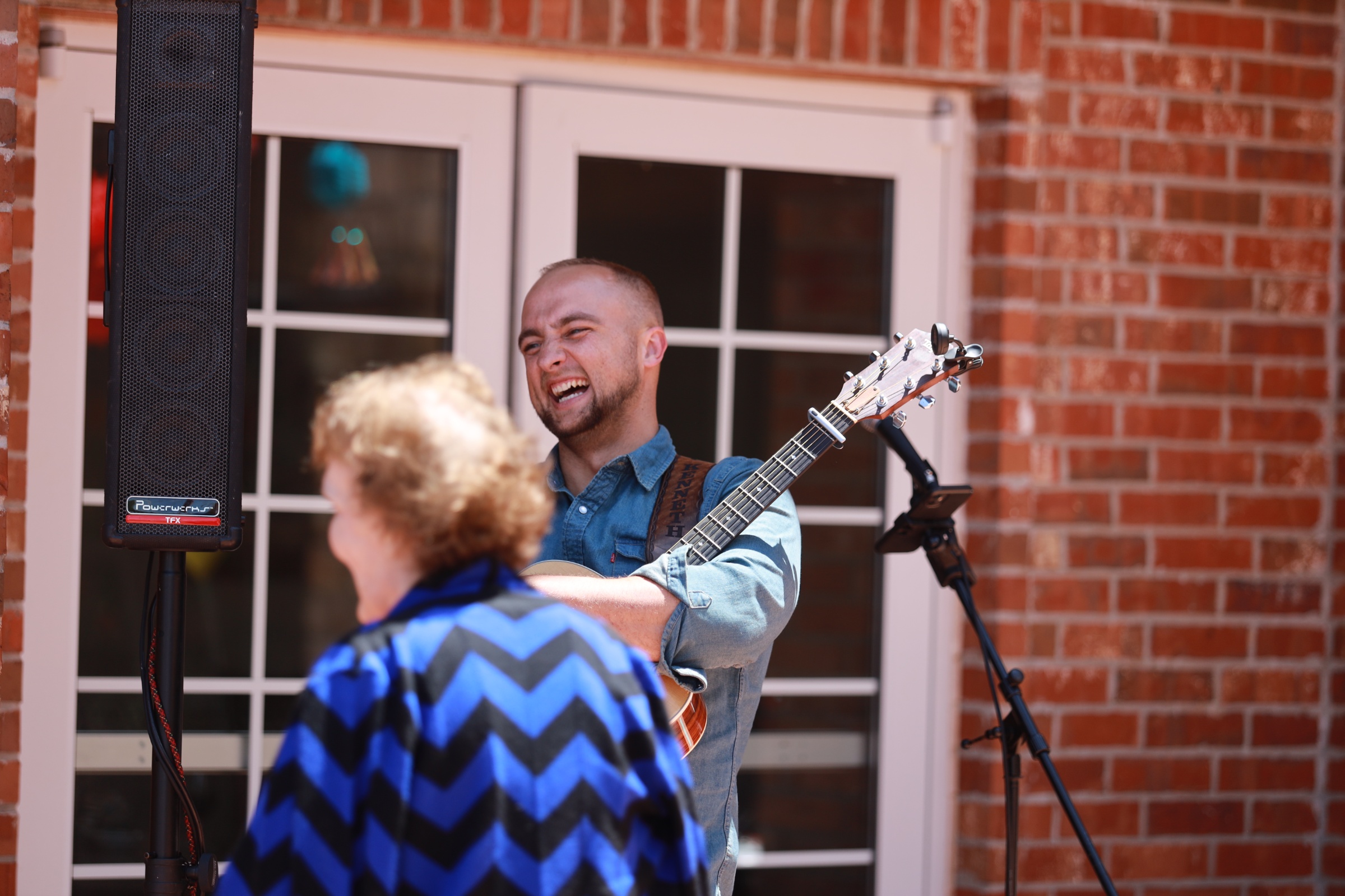 A musician performing for residents in a common area