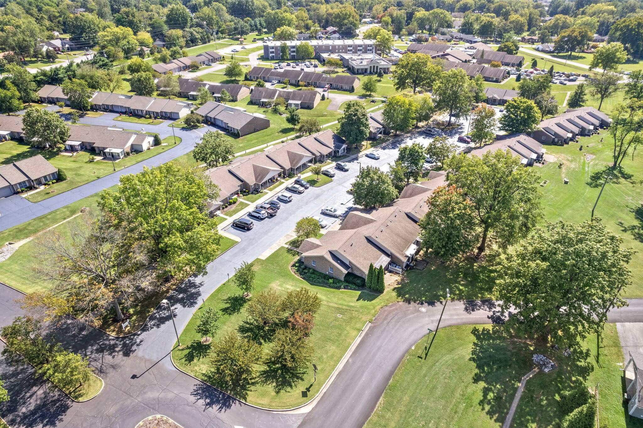 Aerial view of the assisted living community with landscaped grounds.