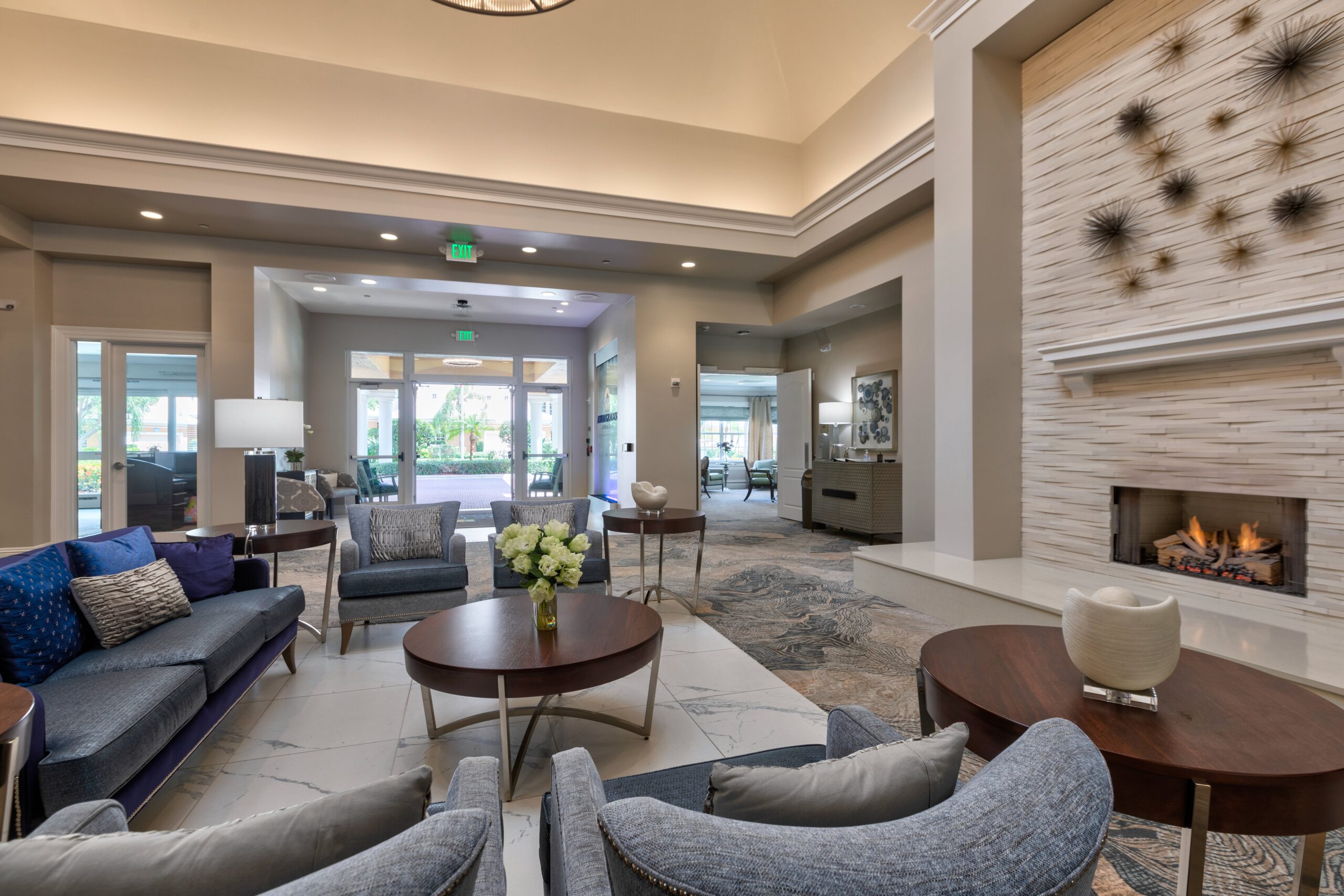 Bright and welcoming common area with seating and fireplace