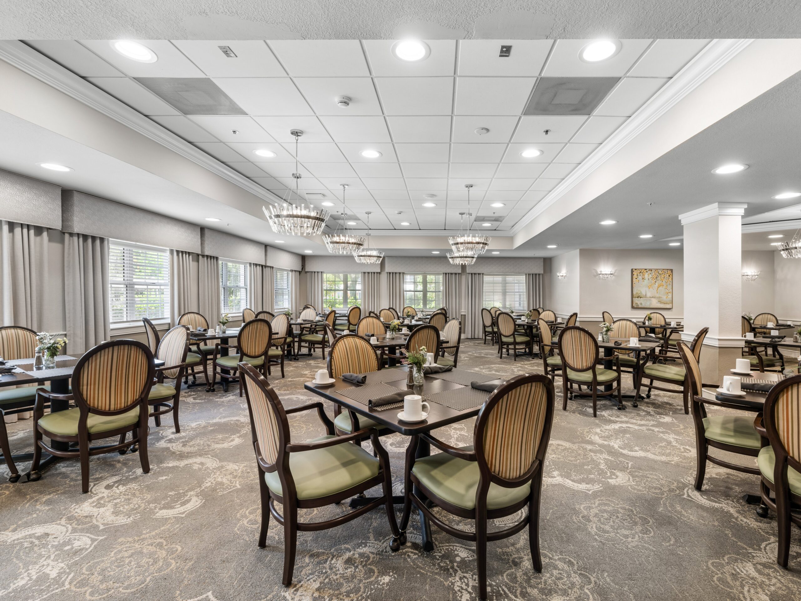 Dining room with tables and chairs set for meals