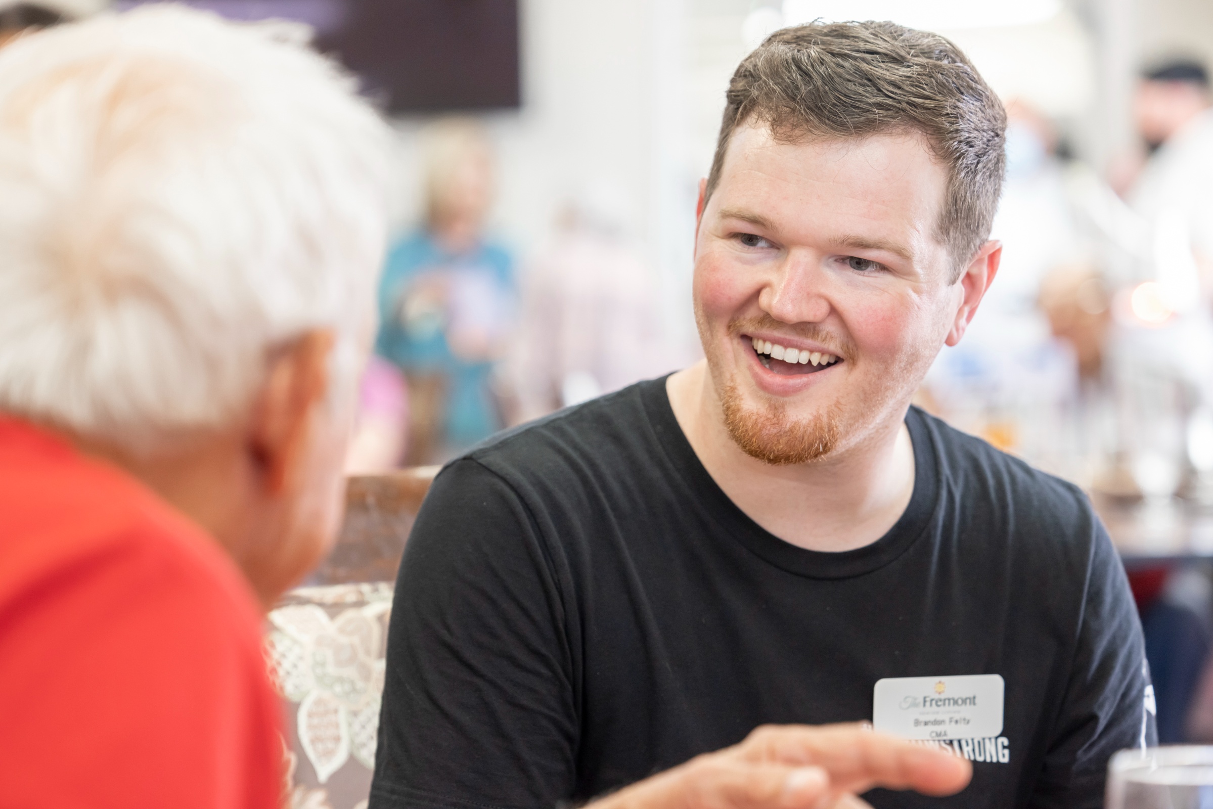 A staff member engaging with a resident in a common area