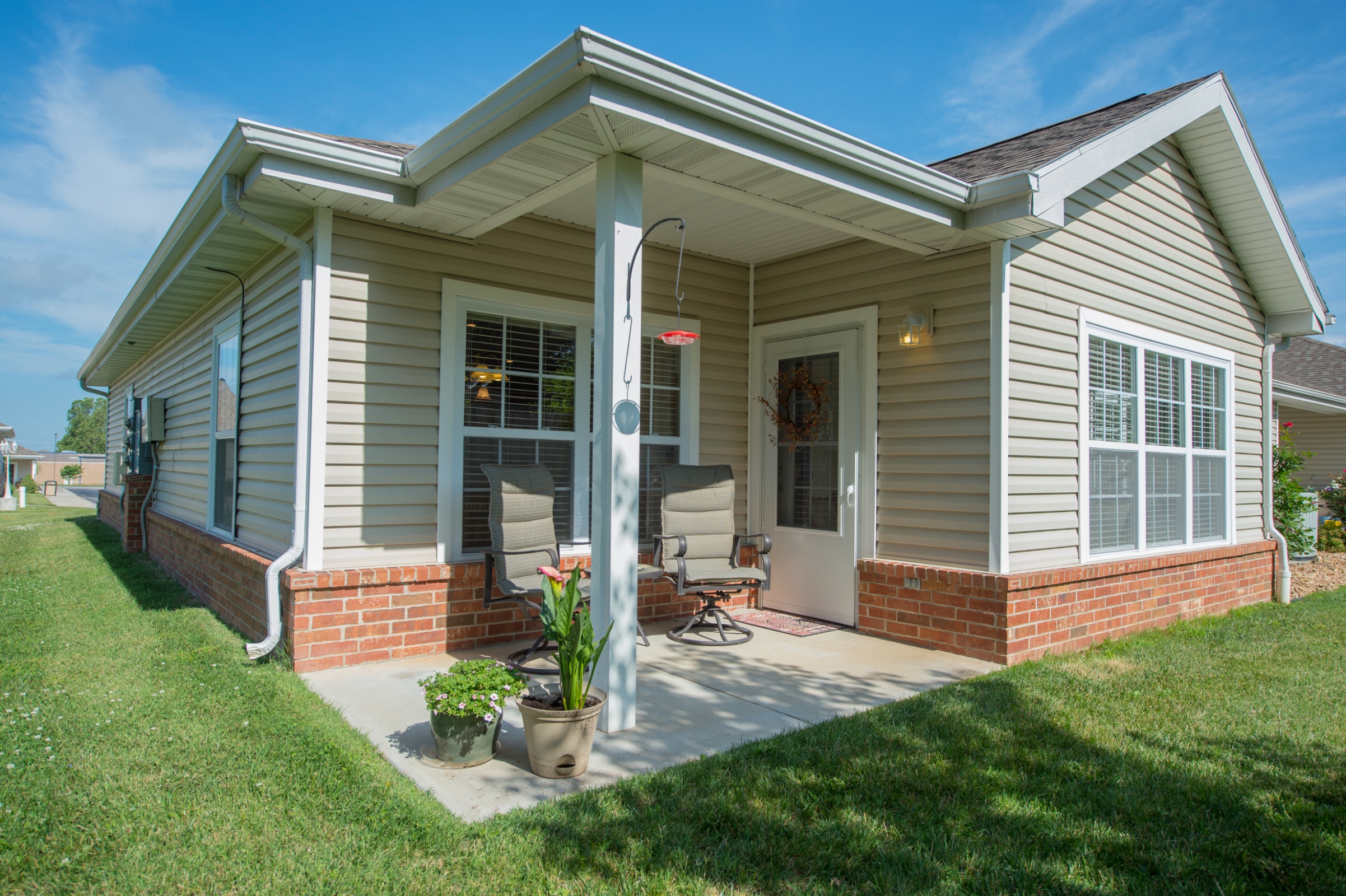 Exterior view of a senior living facility home with patio