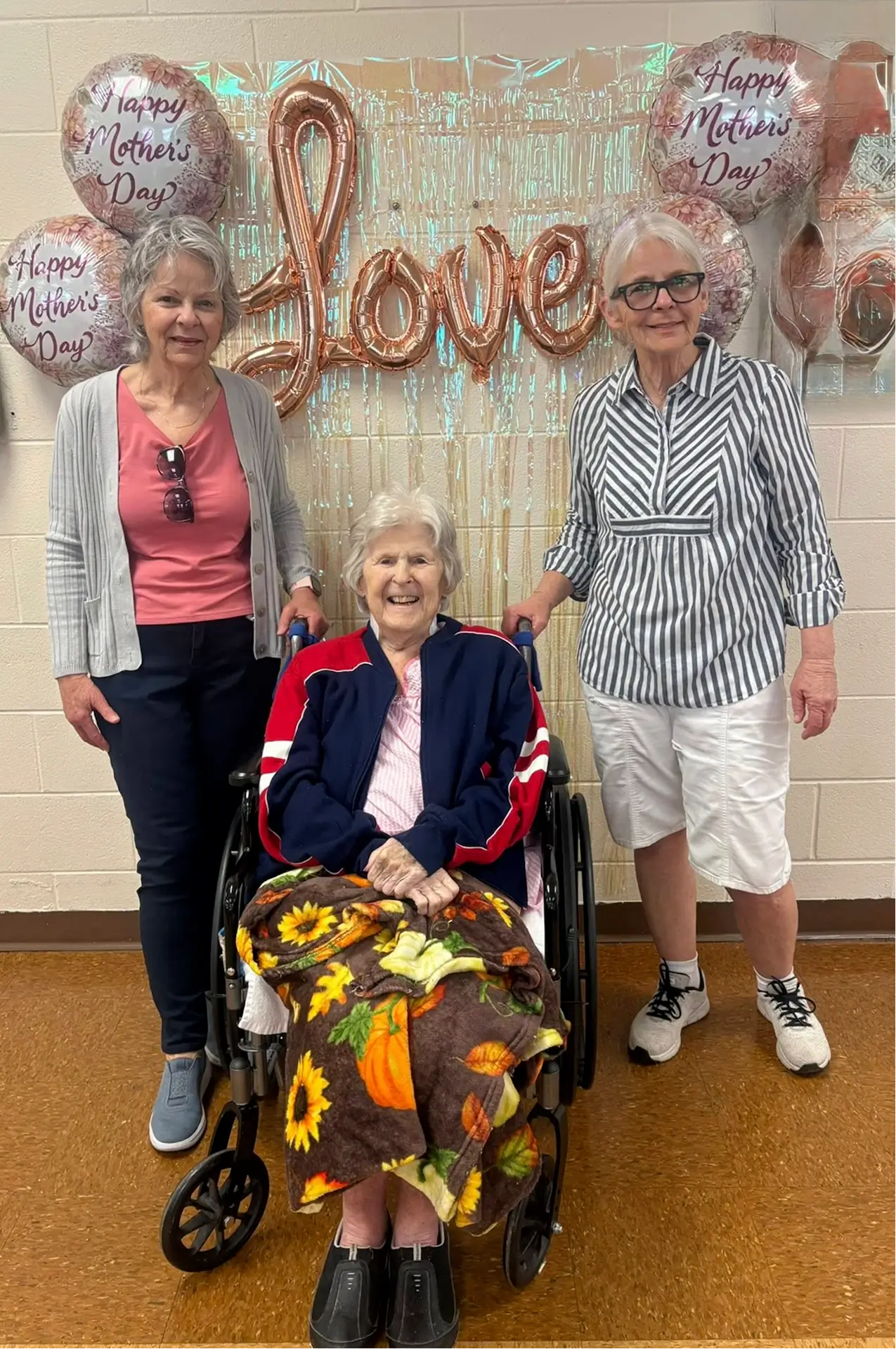 Residents celebrating Mother's Day with staff in a common area