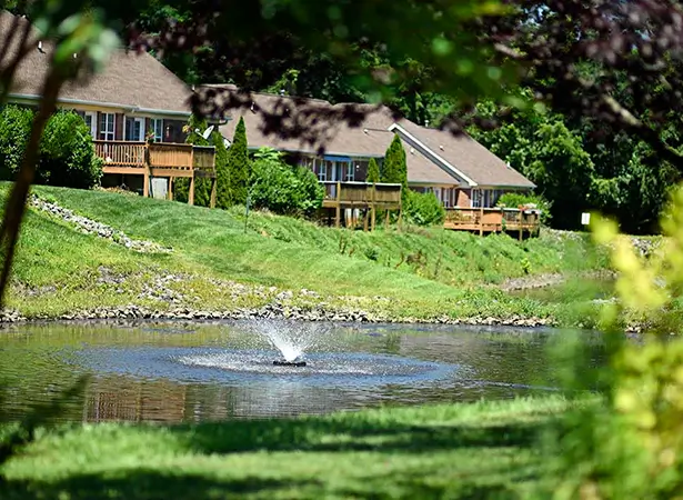 Scenic view of the facility's outdoor space with a pond