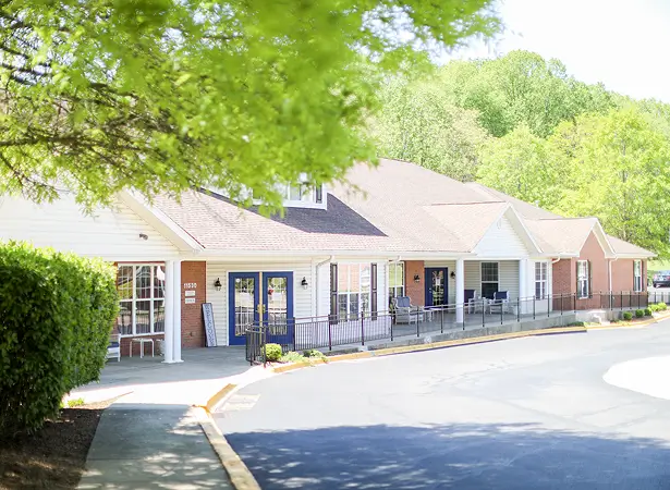 Exterior view of a senior living facility with trees