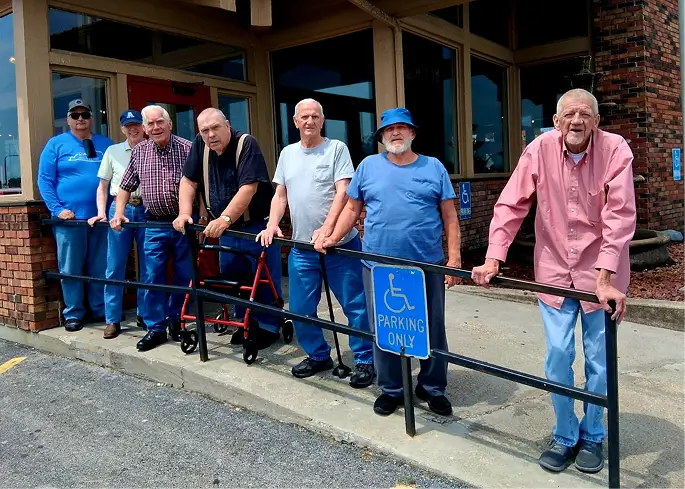 Residents posing outside the facility