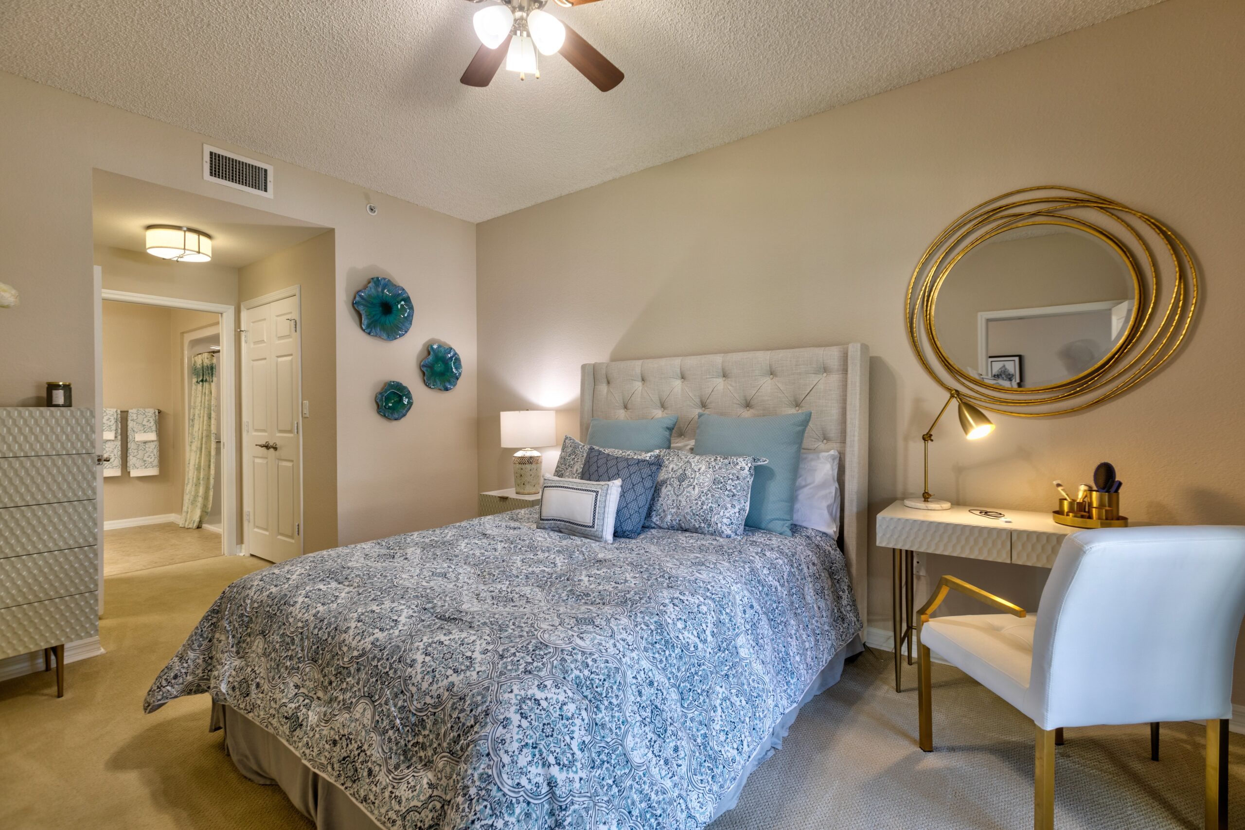 A beautifully decorated resident room with a bed and desk