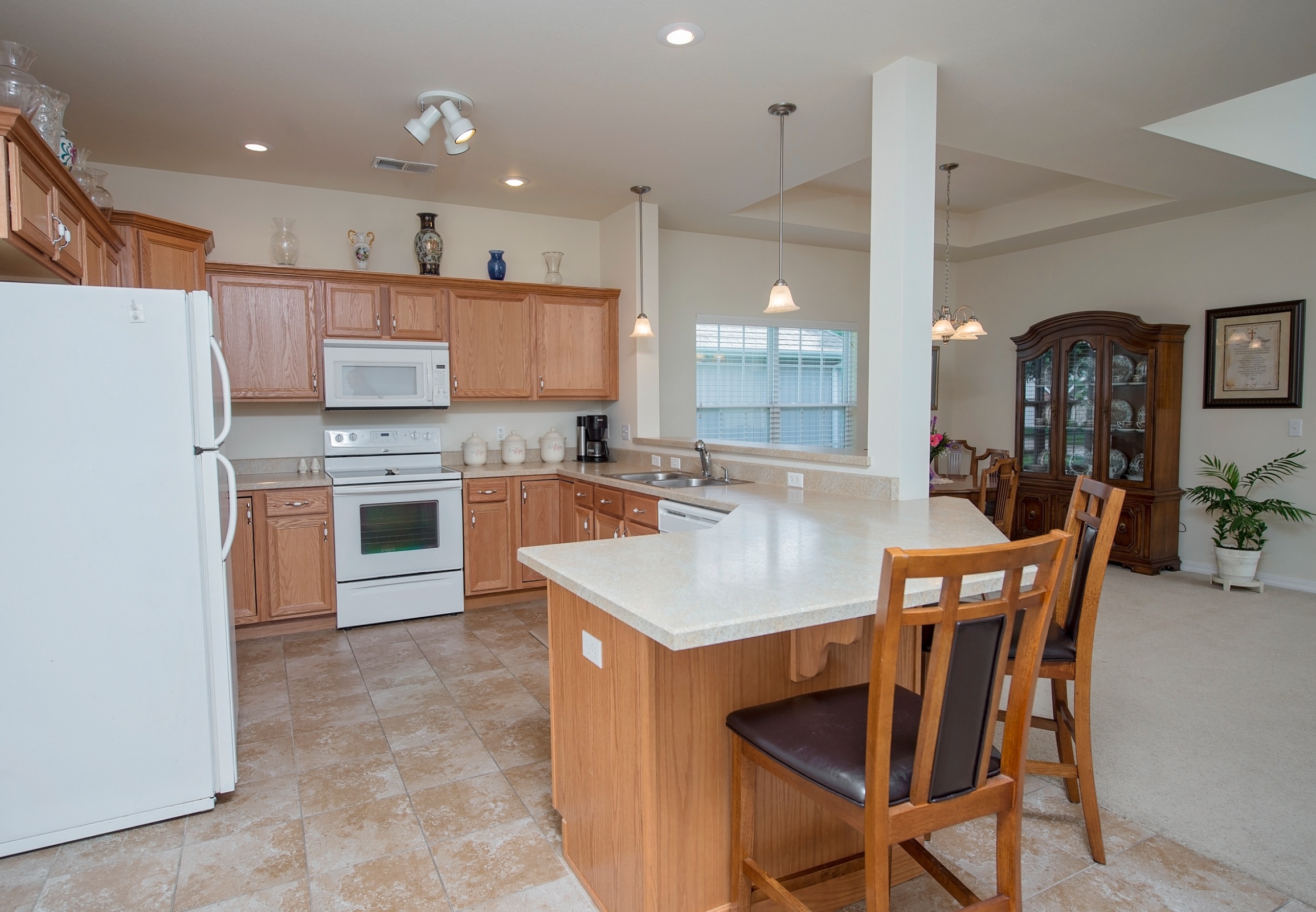 A well-equipped kitchen with wooden cabinetry and appliances