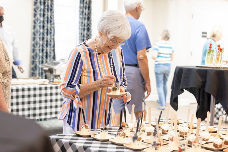 Senior resident enjoying desserts at a community gathering