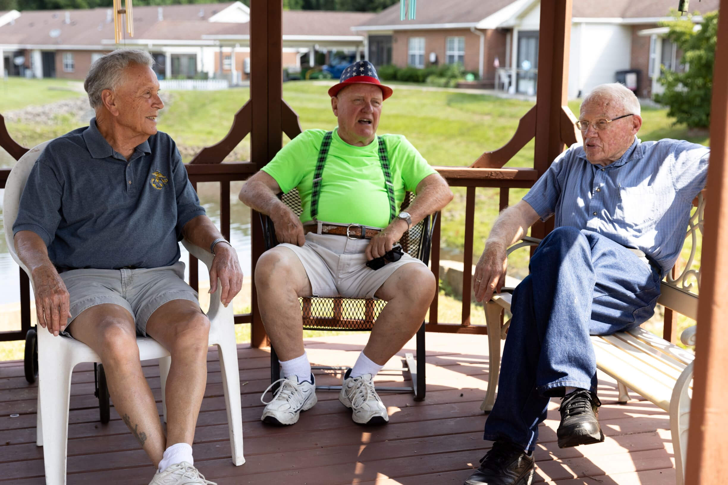 Three residents enjoying conversation on a gazebo porch