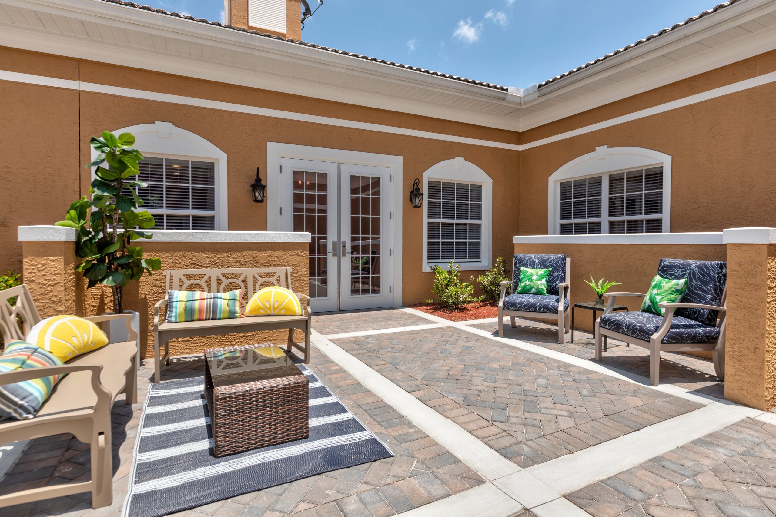 Outdoor seating area with plants and decorative cushions
