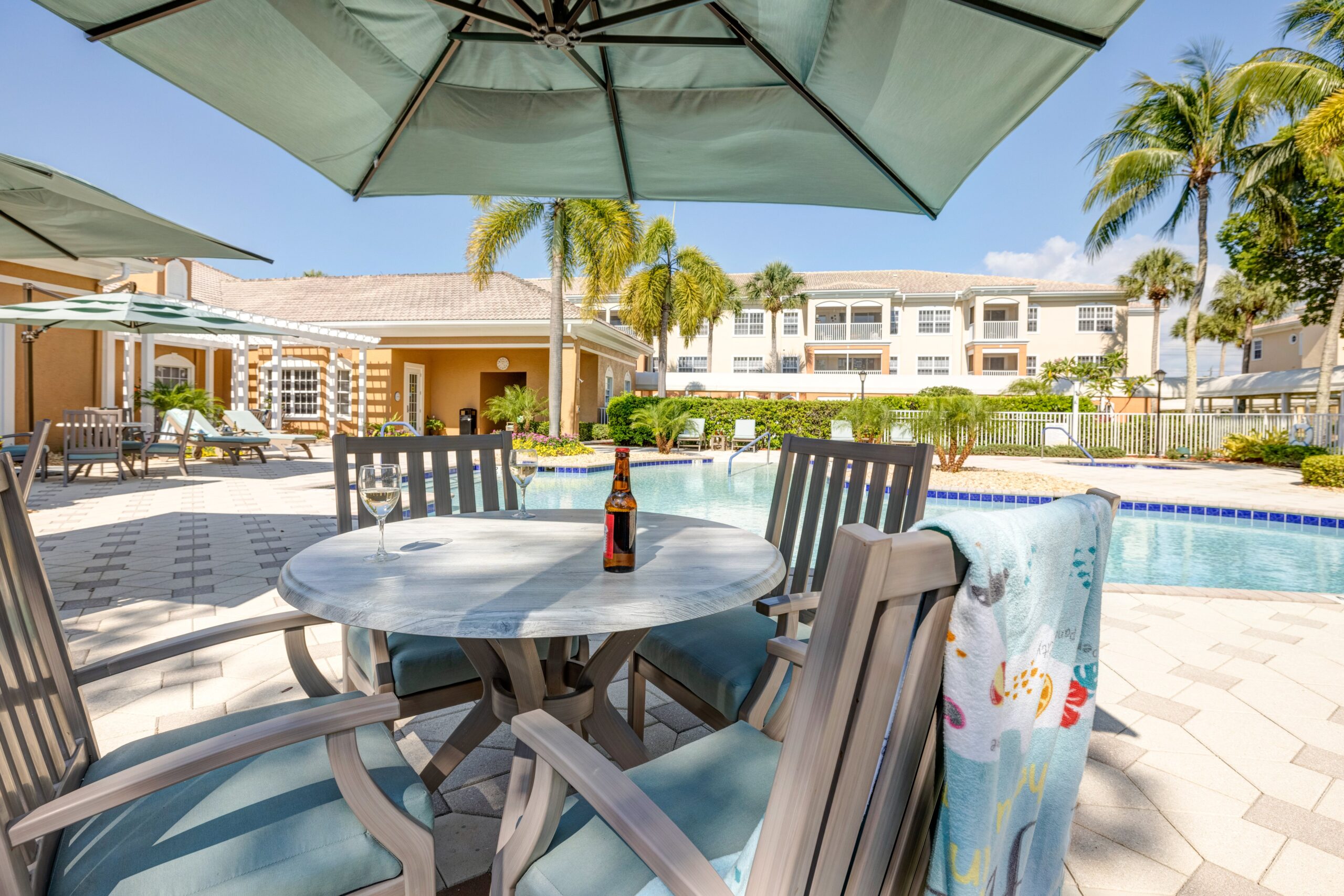 Scenic poolside area with outdoor seating and umbrellas