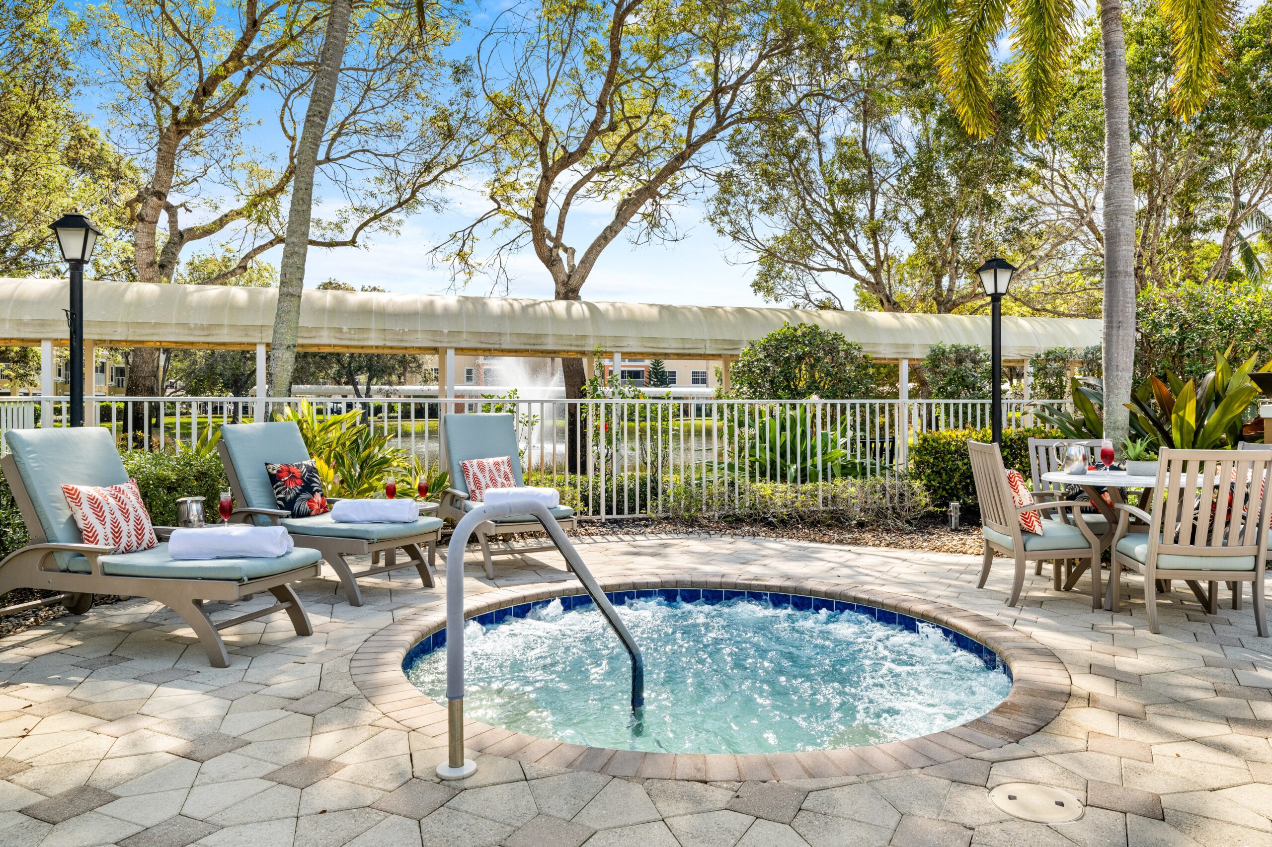 Outdoor spa area with lounge chairs and tables