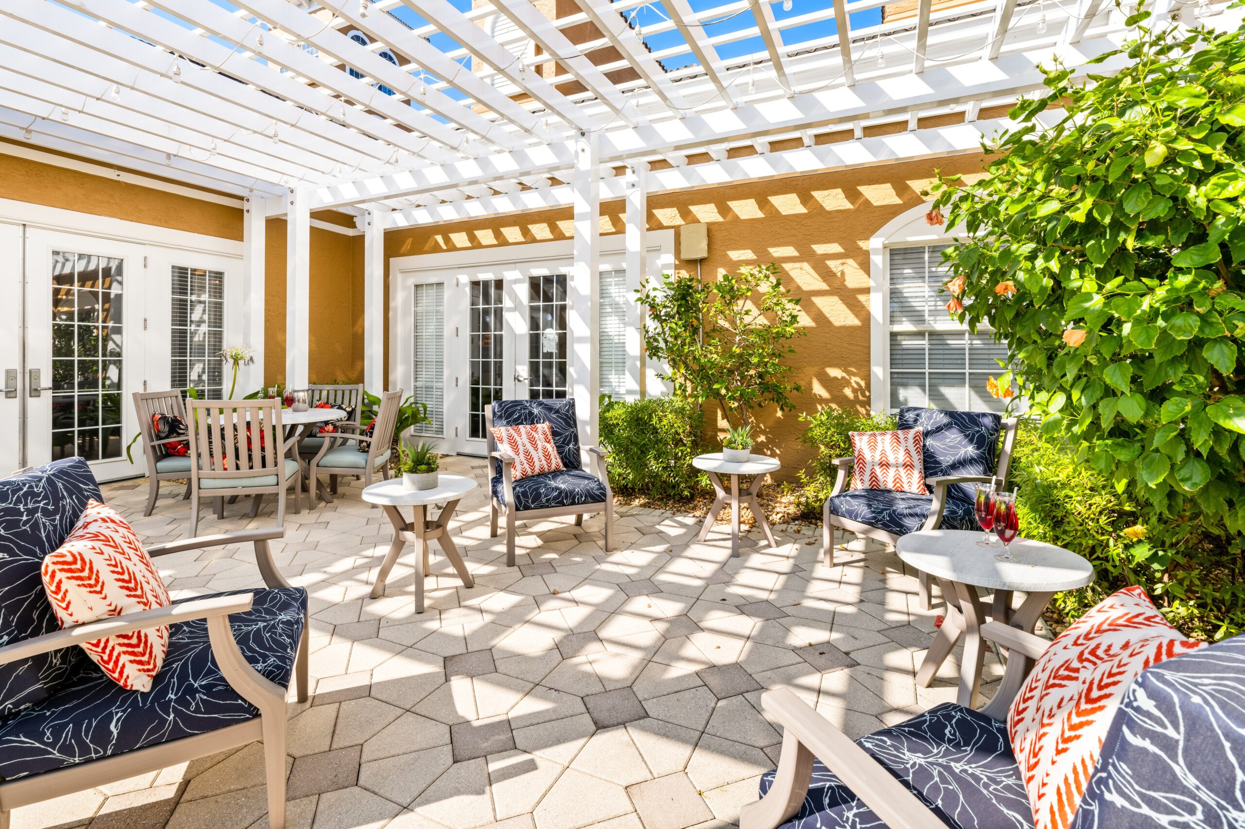 Outdoor seating area with green plants and chairs