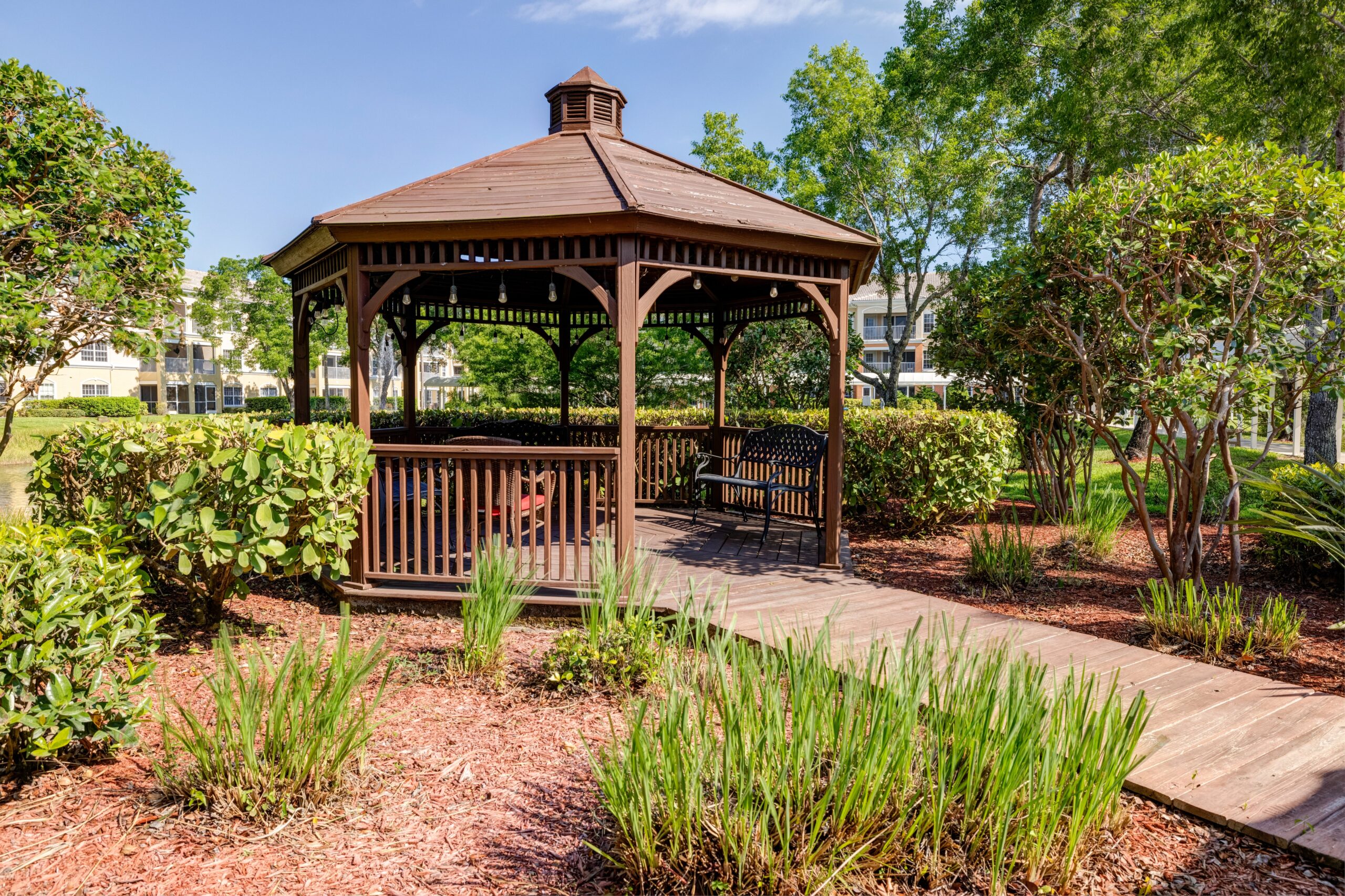 Wooden gazebo in a landscaped garden area