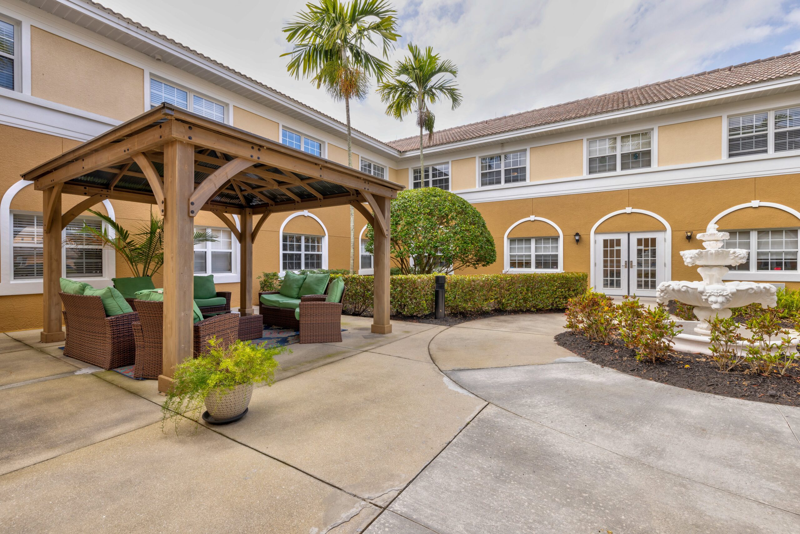 Outdoor seating area with palm trees and fountain