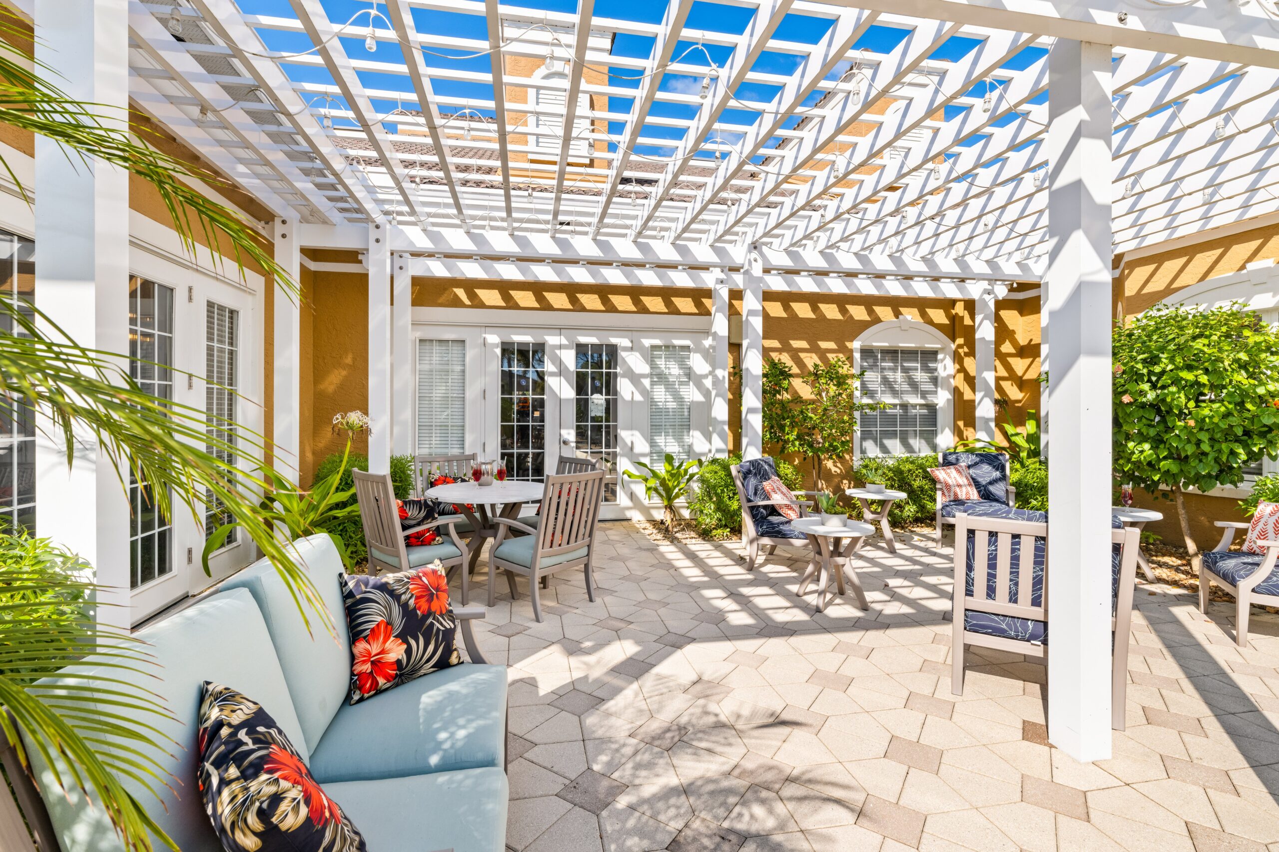 Outdoor patio area with seating and greenery