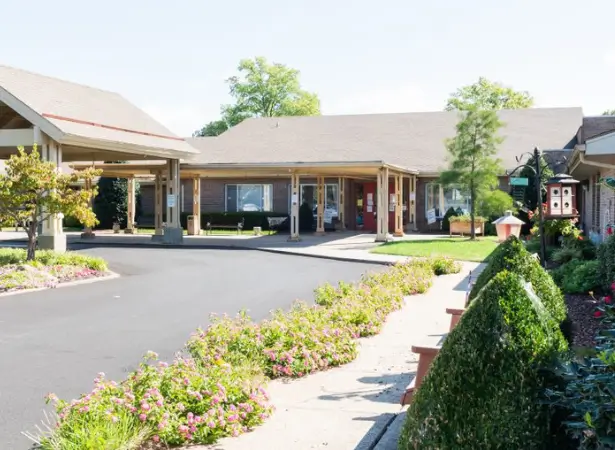 Exterior view of the assisted living facility with gardens